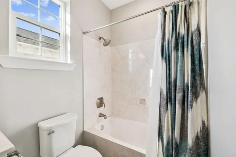 a bedroom with a white bed and white walls