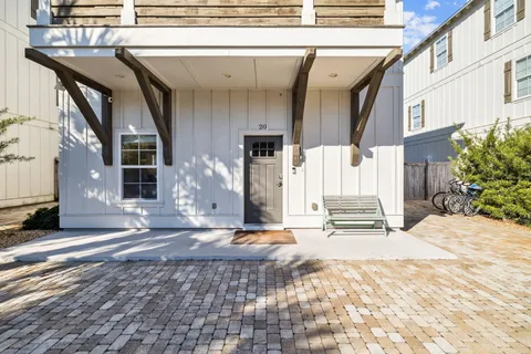a view of a hallway with wooden floor and entryway