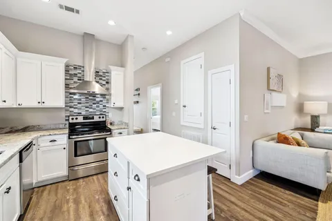 a stove top oven sitting inside of a kitchen