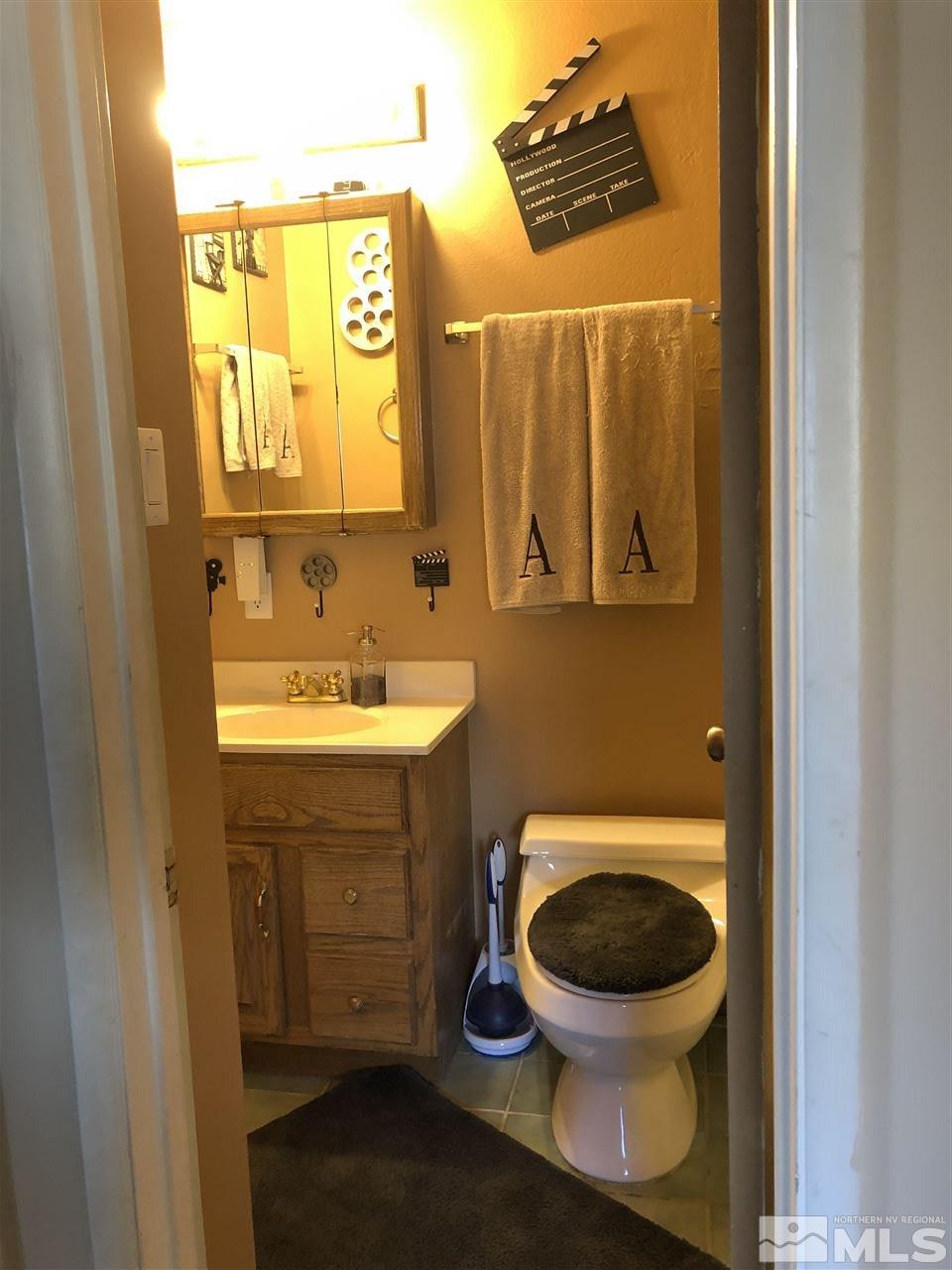 3351 Bryan Street Reno, NV 89503 - Photo 14 of 24 a bathroom with a toilet sink and mirror