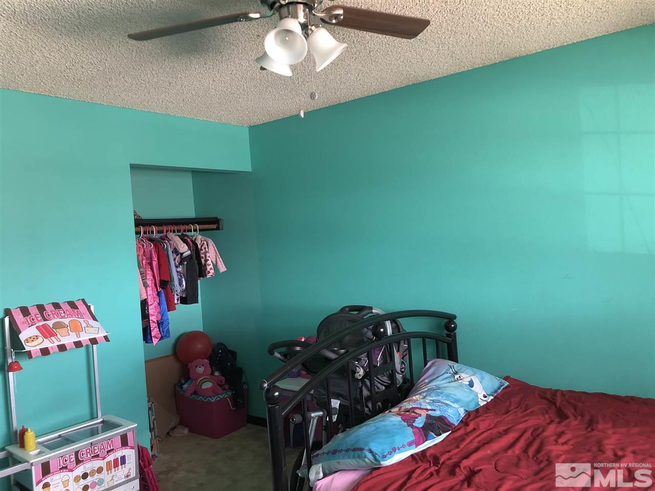 3351 Bryan Street Reno, NV 89503 - Photo 15 of 24 a bedroom with a bed and a chandelier