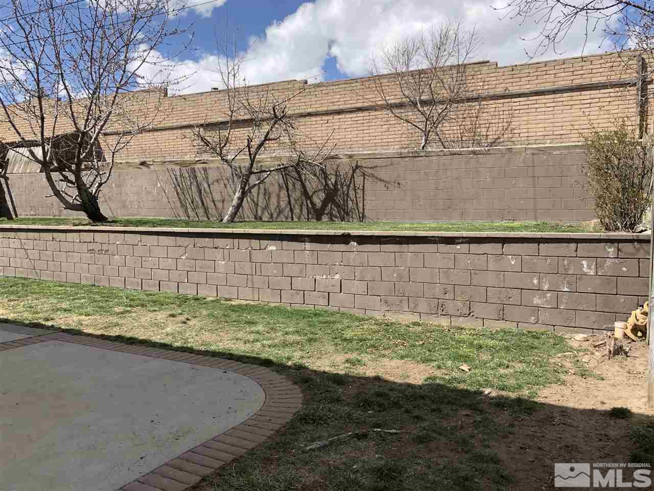 3351 Bryan Street Reno, NV 89503 - Photo 19 of 24 a view of a back yard of the house and a wooden fence