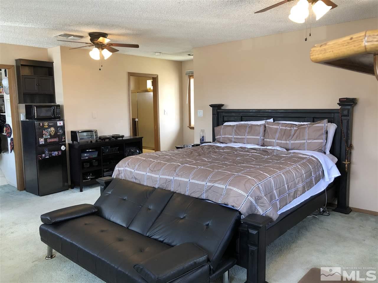 3351 Bryan Street Reno, NV 89503 - Photo 2 of 24 a bedroom with a bed and a chandelier