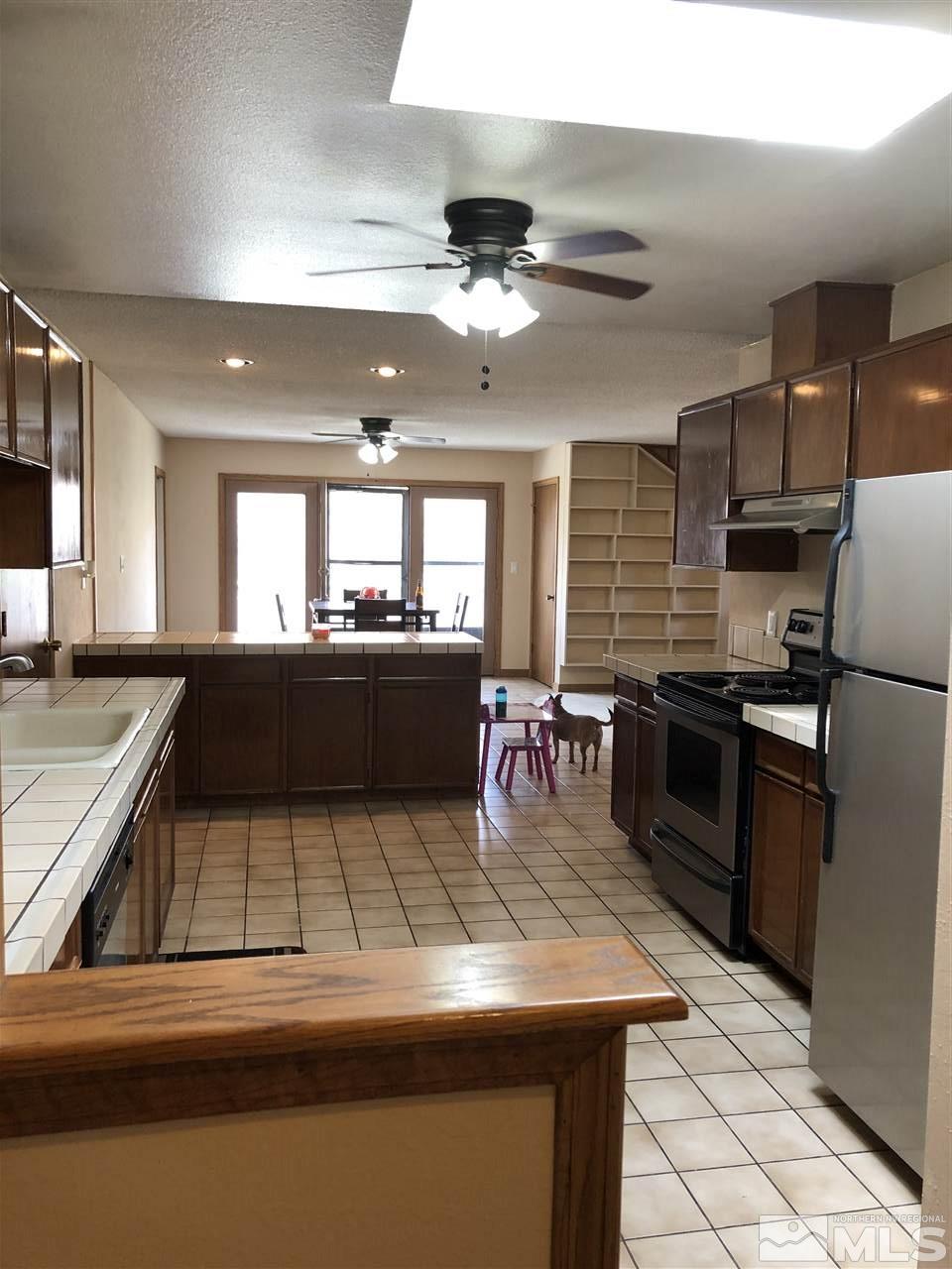 3351 Bryan Street Reno, NV 89503 - Photo 24 of 24 a kitchen with stainless steel appliances granite countertop a sink dishwasher stove and refrigerator