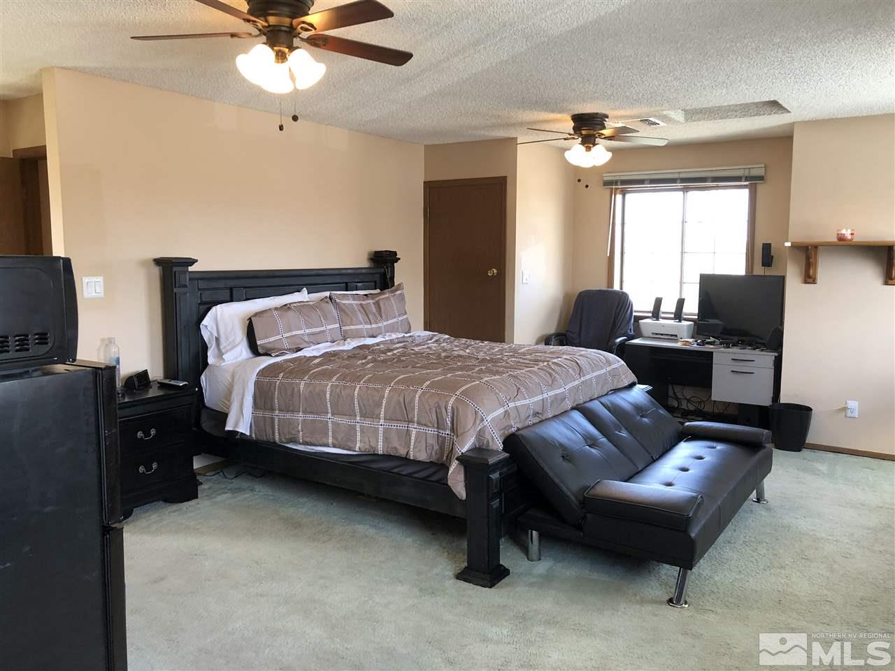 3351 Bryan Street Reno, NV 89503 - Photo 3 of 24 a bedroom with a bed and a chandelier