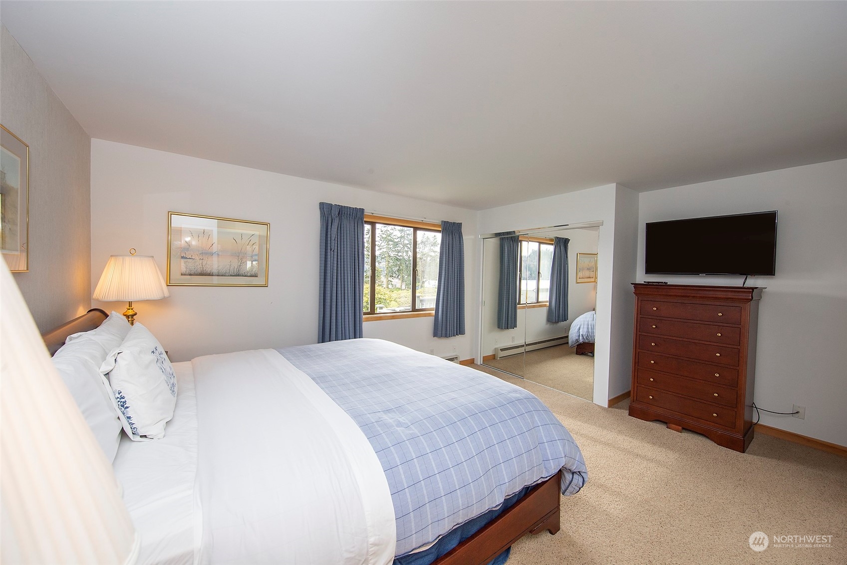 40 Olympic Way, Unit 9 Port Ludlow, WA 98365 - Photo 15 of 35 a bedroom with a bed and a flat screen tv