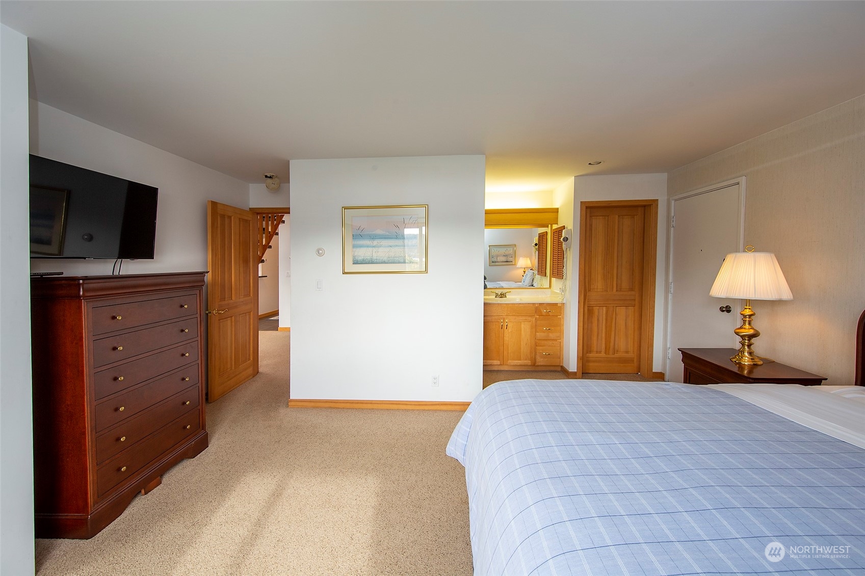 40 Olympic Way, Unit 9 Port Ludlow, WA 98365 - Photo 16 of 35 a bedroom with a bed and a flat screen tv