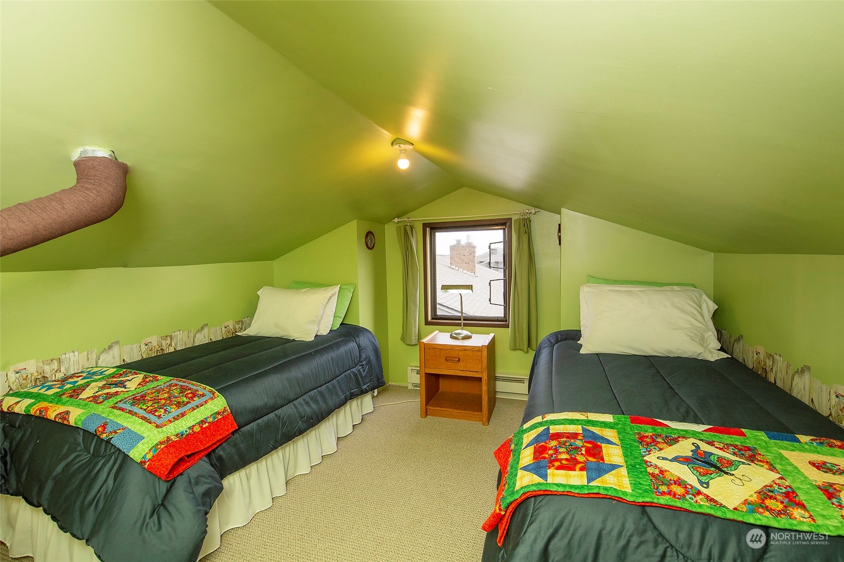 40 Olympic Way, Unit 9 Port Ludlow, WA 98365 - Photo 20 of 35 a bedroom with a bed a table and painting on the wall