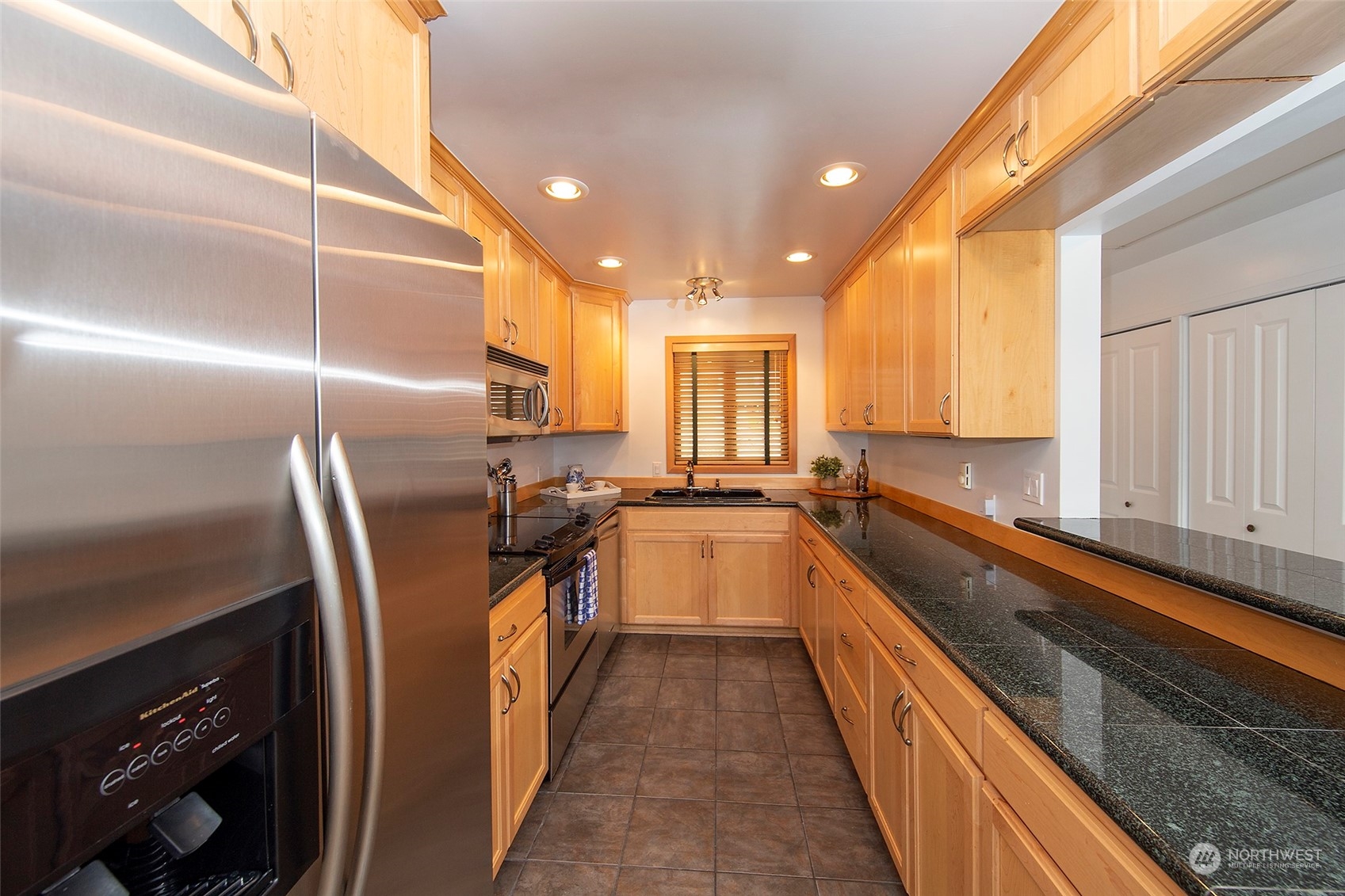 40 Olympic Way, Unit 9 Port Ludlow, WA 98365 - Photo 8 of 35 a kitchen with granite countertop lots of counter top space and stainless steel appliances