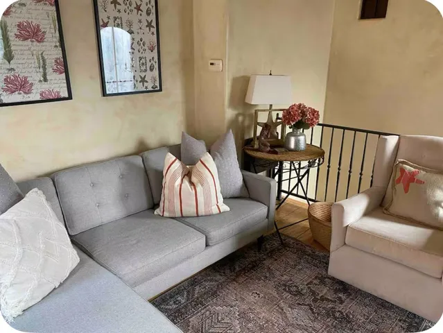 a living room with furniture and a rug