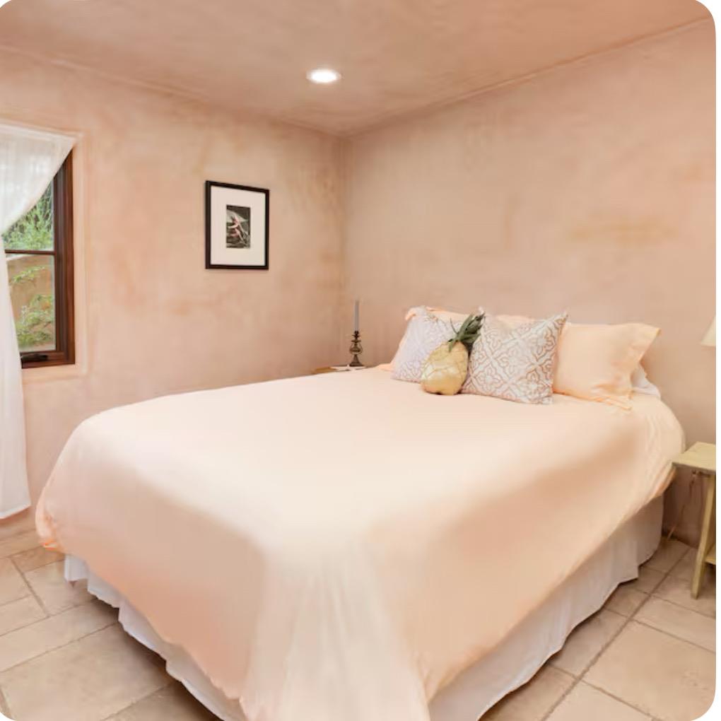 759 Rockaway Beach Avenue Pacifica, CA 94044 - Photo 6 of 20 a bedroom with a bed and painting on the wall