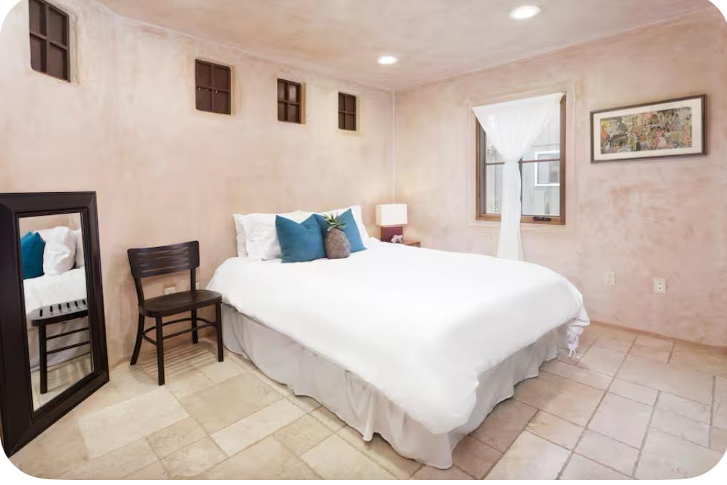 759 Rockaway Beach Avenue Pacifica, CA 94044 - Photo 9 of 20 a bedroom with a bed and a chair