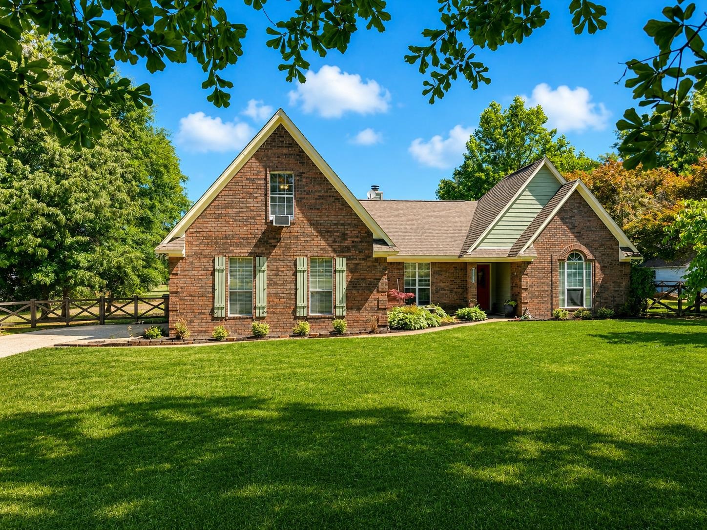 Brick exterior with gabled roof lines and light green architectural accents