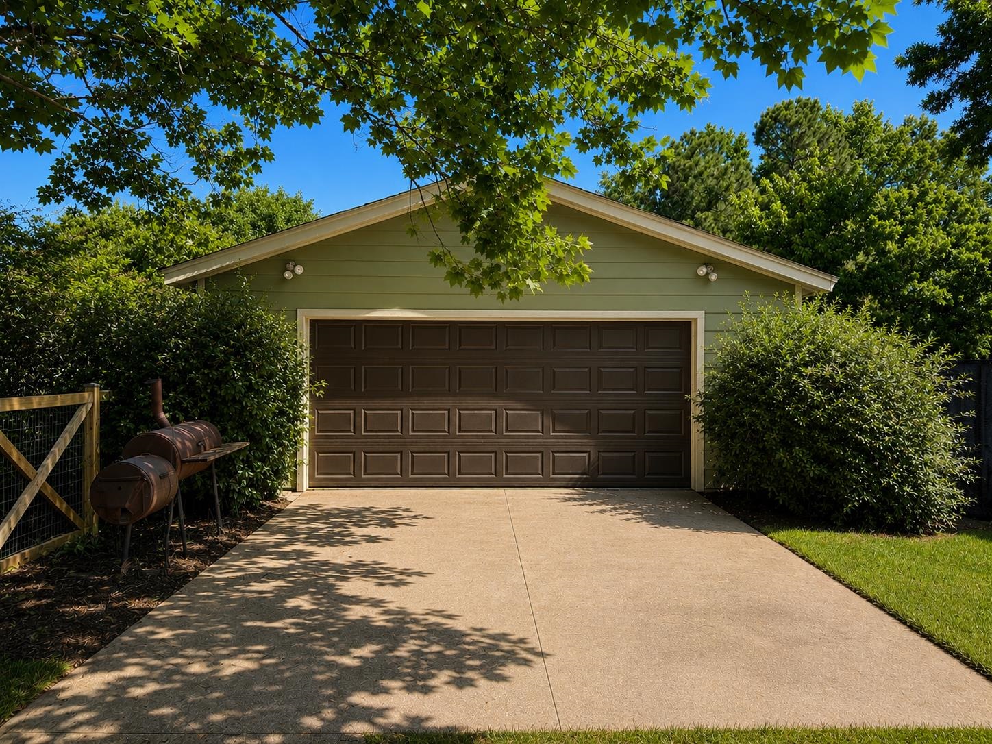 1946 Little John Road Millington, TN 38053 - Photo 15 of 20 Detached two-car garage with a brown panel door, light green siding, and a concrete driveway, Shop.