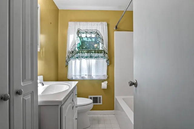 a bathroom with a sink a toilet and tub