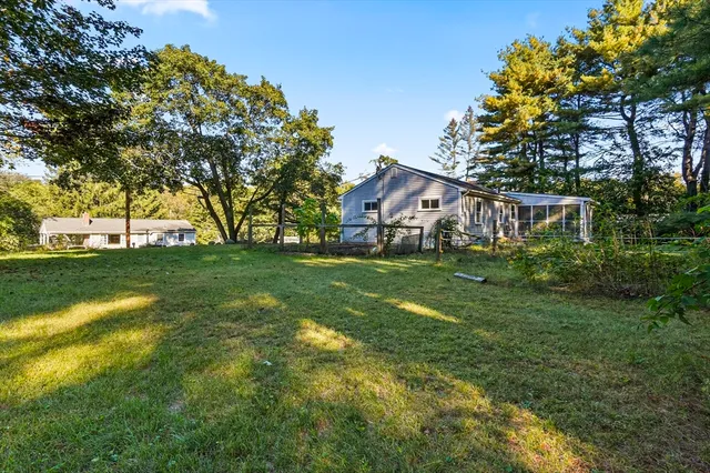 a view of house with a yard