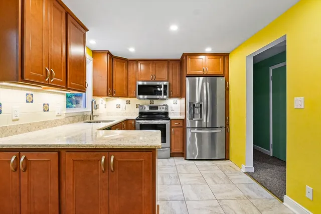 a kitchen with a refrigerator sink and microwave