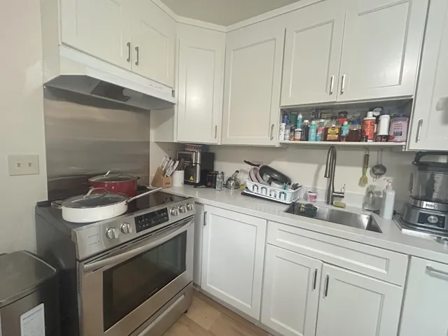 a kitchen with stainless steel appliances granite countertop a sink and a stove
