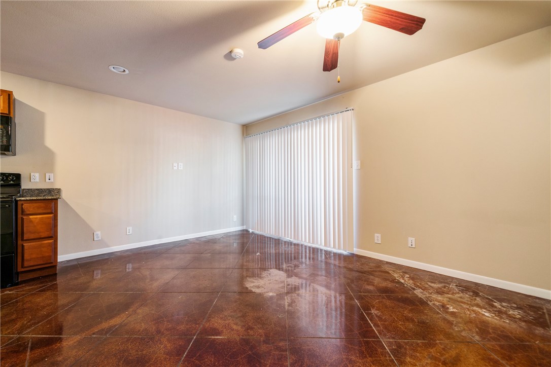 301 West 38th Street, Unit 106 Austin, TX 78705 - Photo 13 of 16 an empty room with wooden floor fan and windows