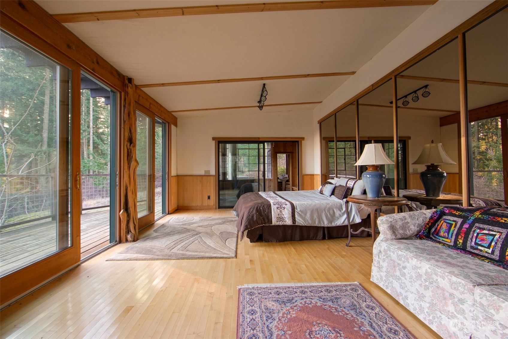 549 White Beach Road Orcas Island, WA 98280 - Photo 19 of 38 a bedroom with bed and glass window