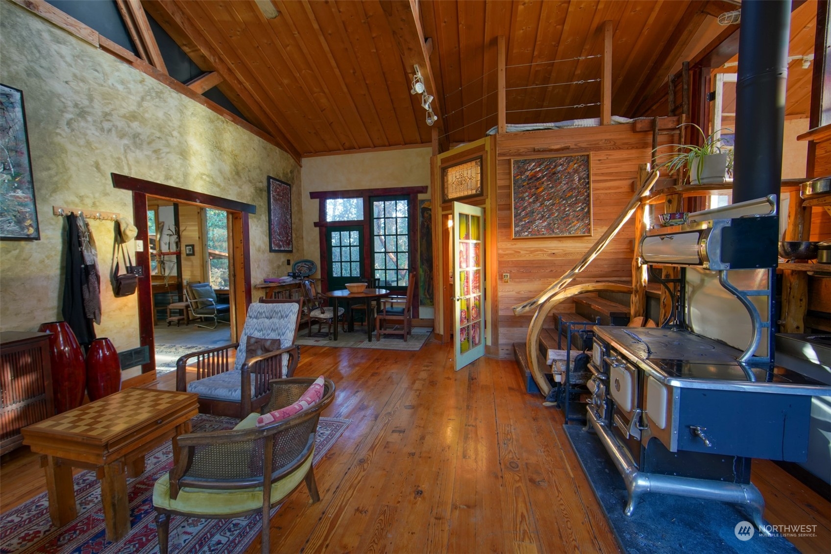 549 White Beach Road Orcas Island, WA 98280 - Photo 6 of 38 a living room with furniture floor to ceiling window and wooden floor