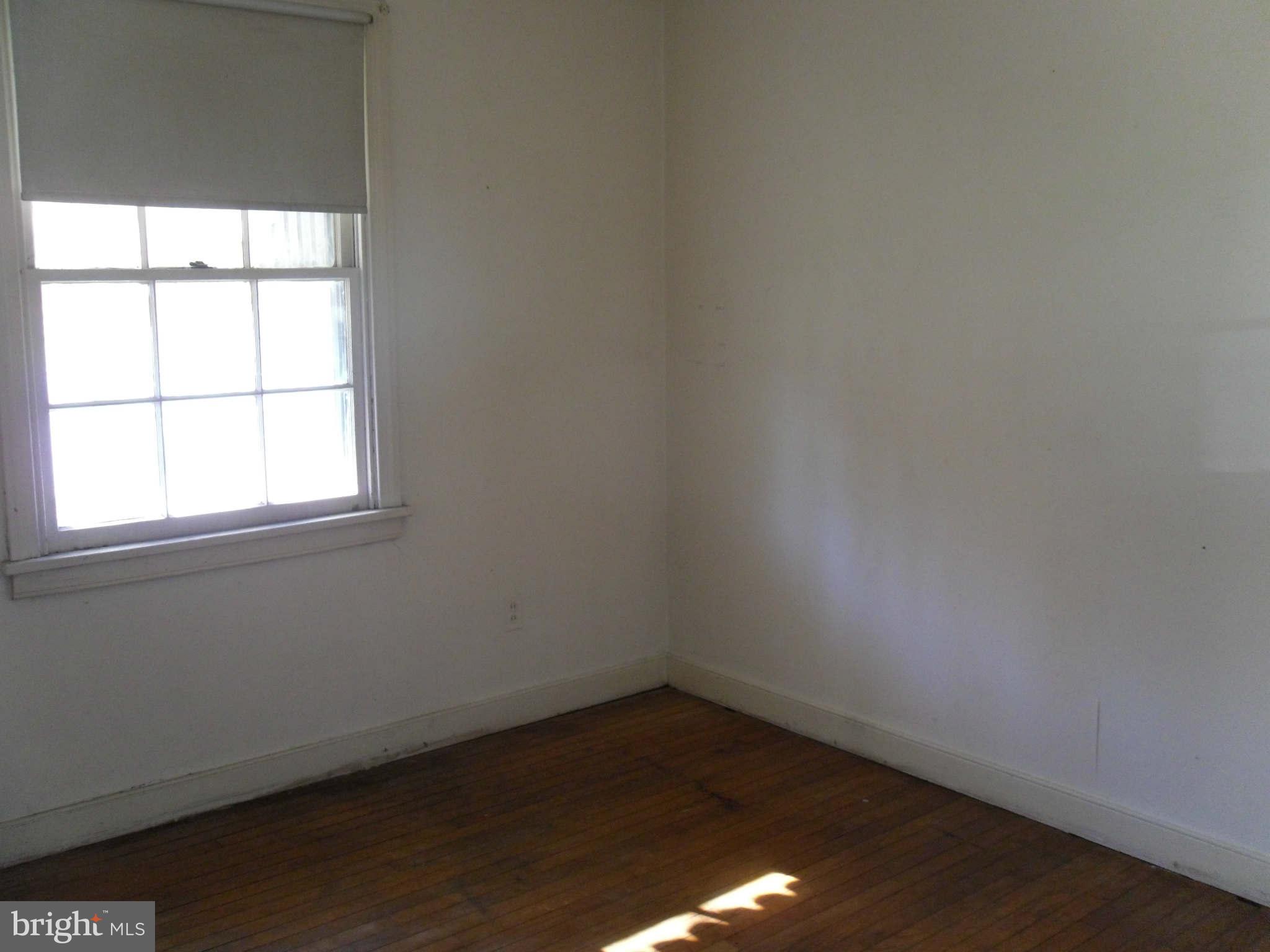 2407 Randolph Road Silver Spring, MD 20906 - Photo 5 of 6 an empty room with wooden floor and windows
