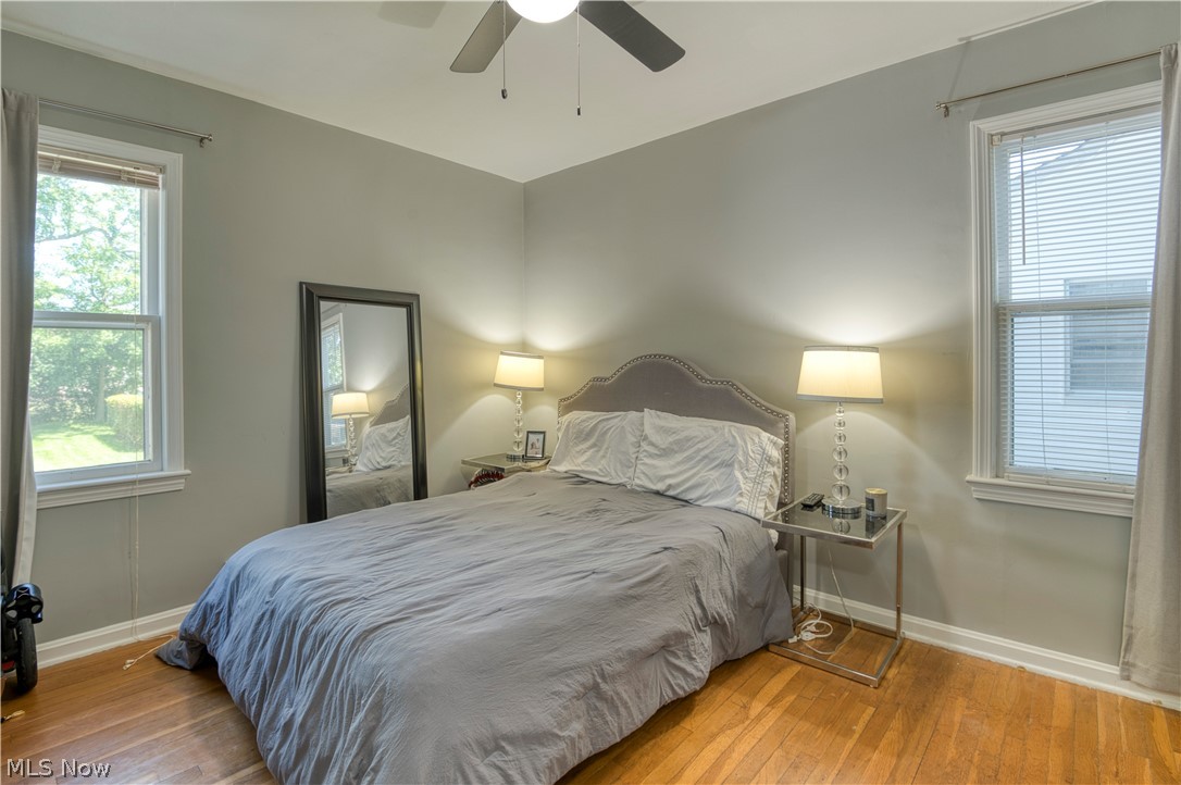 1265 Sunset Road Cleveland, OH 44124 - Photo 13 of 26 Bedroom featuring ceiling fan, multiple windows, and wood-type flooring