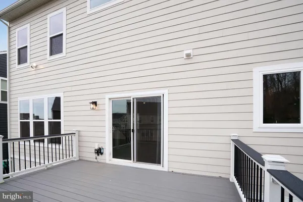 a kitchen with white cabinets and sink