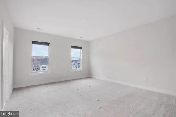 a view of a sign board with yard and lake view