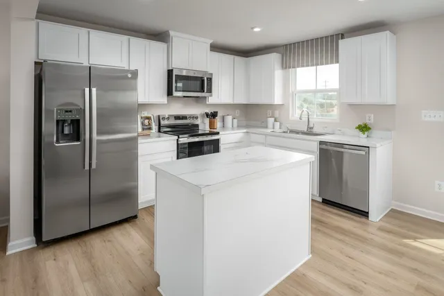 a kitchen with a refrigerator sink and microwave