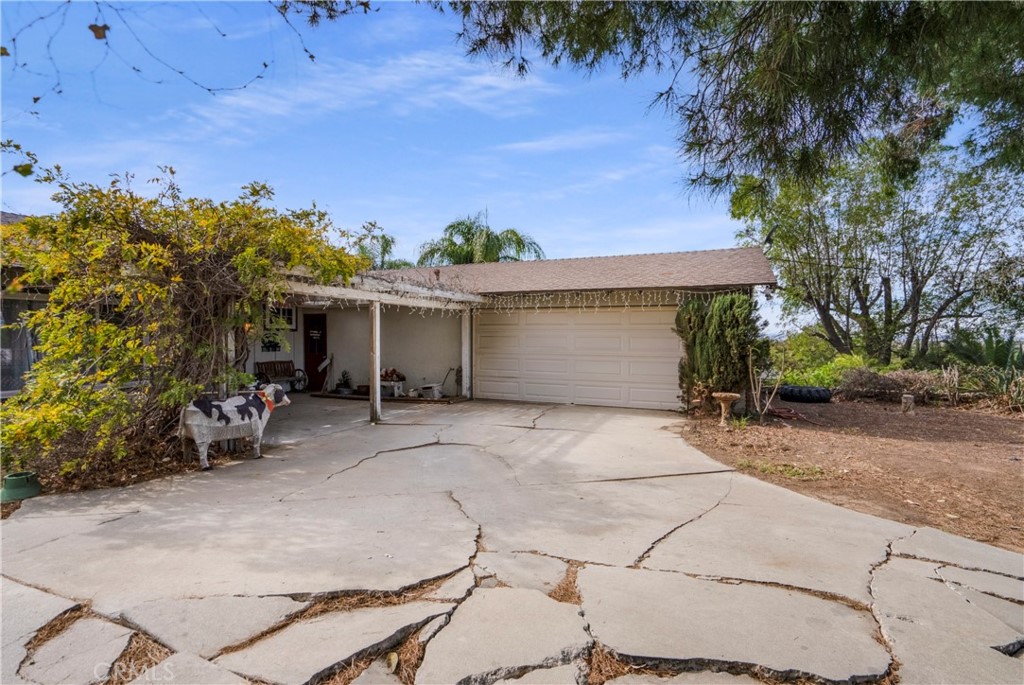 172 Eighth Street Norco, CA 92860 - Photo 49 of 55 front view of a house with a yard and a garage