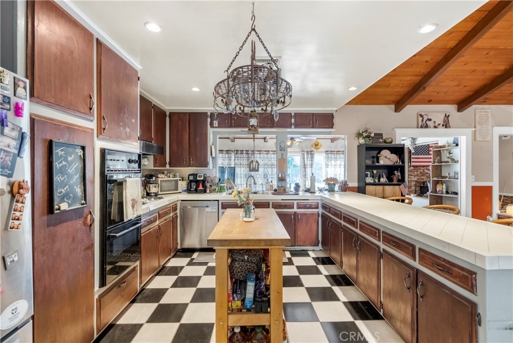 172 Eighth Street Norco, CA 92860 - Photo 9 of 55 a kitchen with stainless steel appliances granite countertop a sink and cabinets