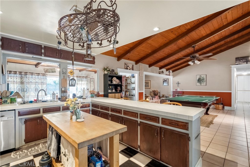 172 Eighth Street Norco, CA 92860 - Photo 10 of 55 a view of a kitchen with kitchen island a stove a counter space a sink cabinets and appliances