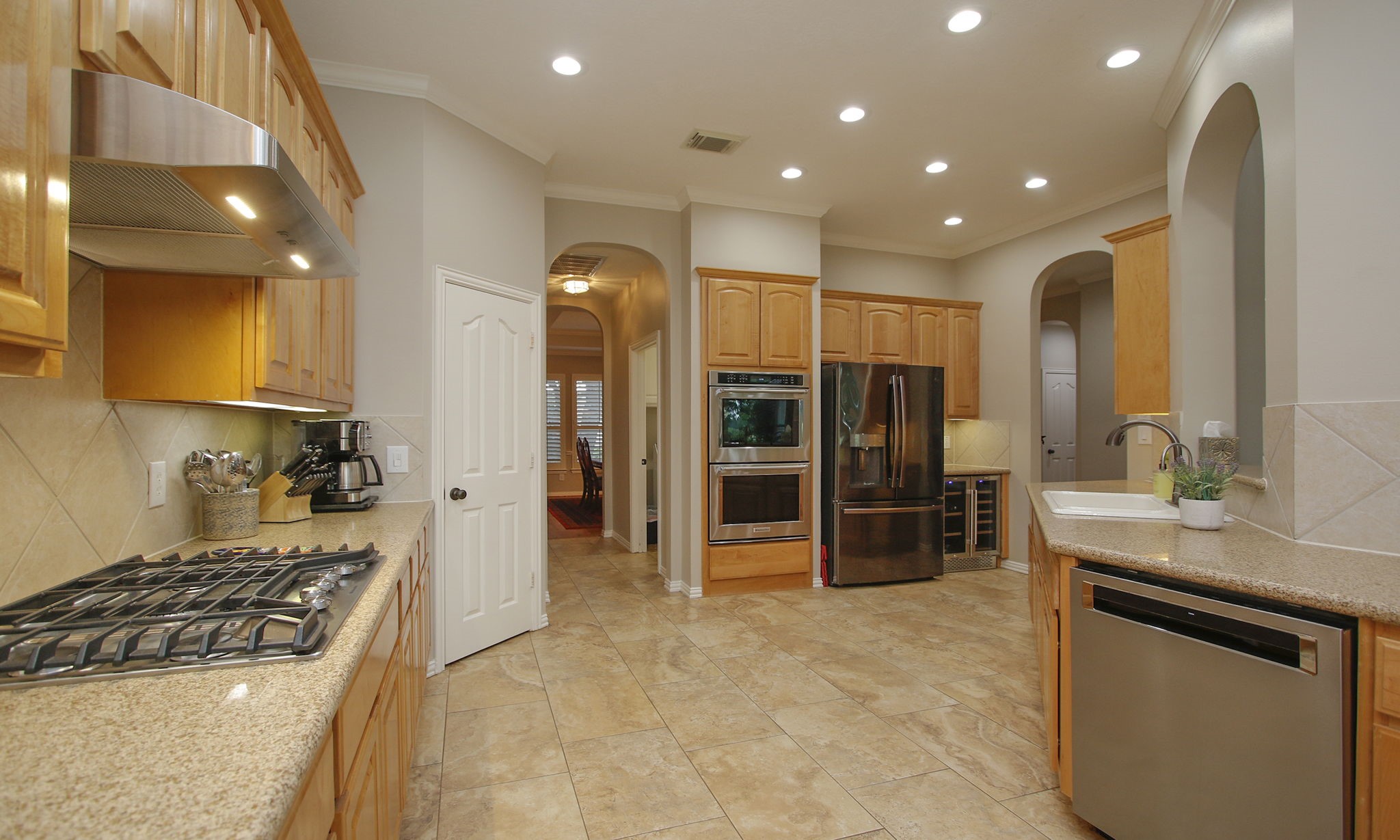 20110 Stormy Pine Lane Spring, TX 77379 - Photo 16 of 44 Exercise your cooking skills in this fabulous kitchen complete with dual ovens, built-in wine fridge, gas cooktop, quartz counters, custom tile and abundant counter and cabinet space!