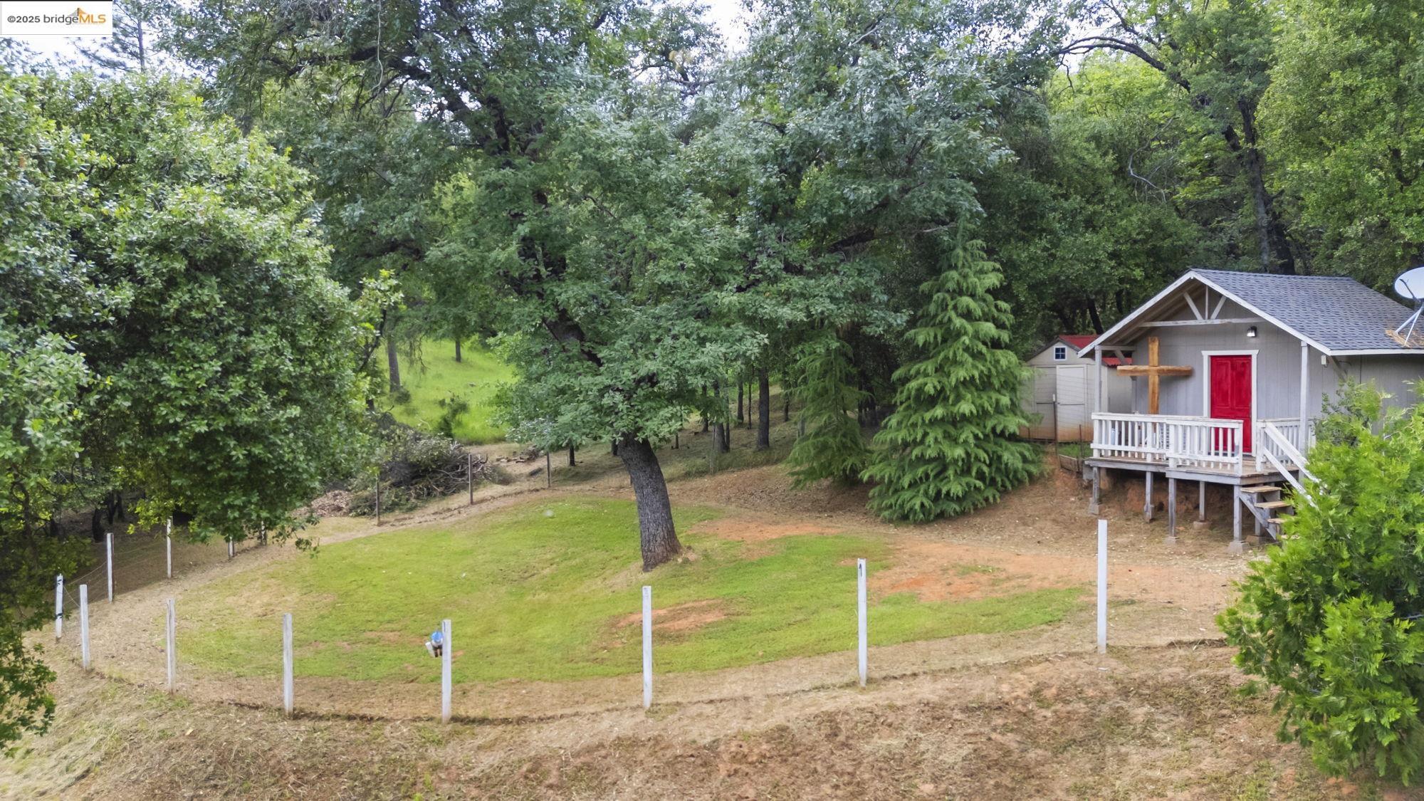 View of grassy yard with an outdoor structure