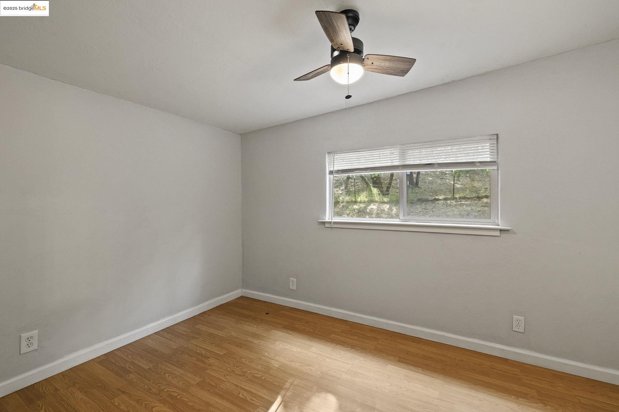 20638 Maranatha Road Tuolumne, CA 95379 - Photo 15 of 60 Spare room with light wood-type flooring and ceiling fan