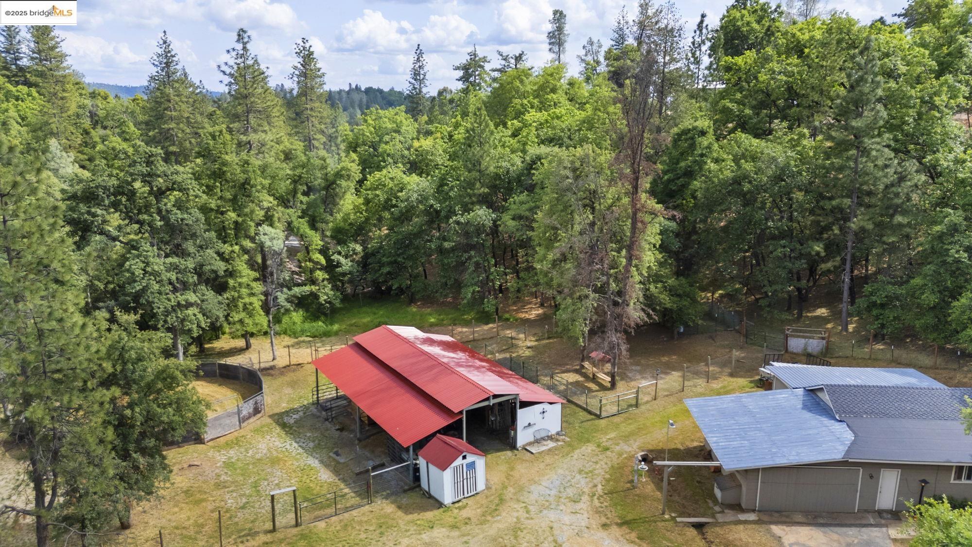 20638 Maranatha Road Tuolumne, CA 95379 - Photo 35 of 60 an outdoor sitting area with furniture and wooden floor
