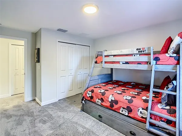 a bedroom with a bed and a lamp