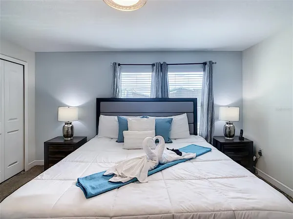 a kitchen with stainless steel appliances a stove a sink a refrigerator a center island a dining table and chairs