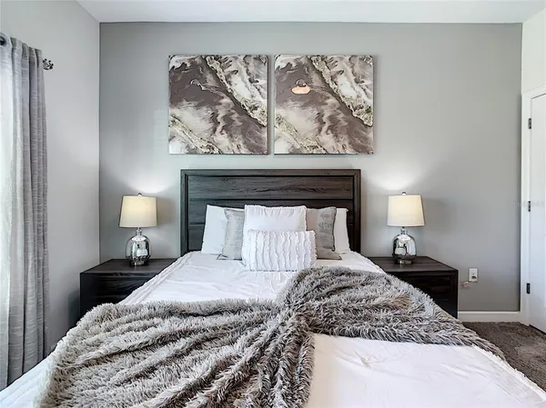 a dining room with furniture a chandelier and kitchen view