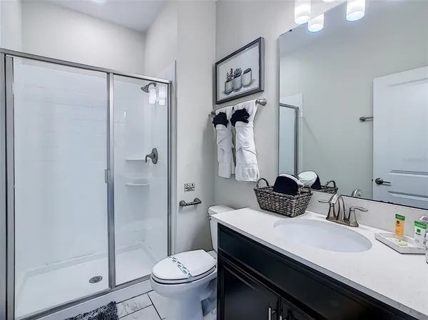 a dining room with furniture and a potted plant