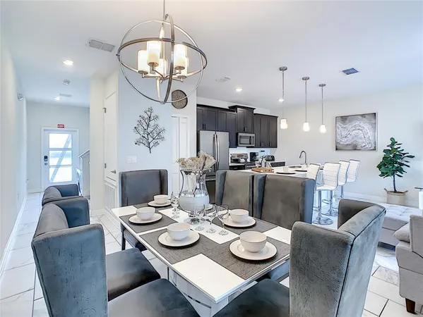 a view of a living room with furniture and floor to ceiling window