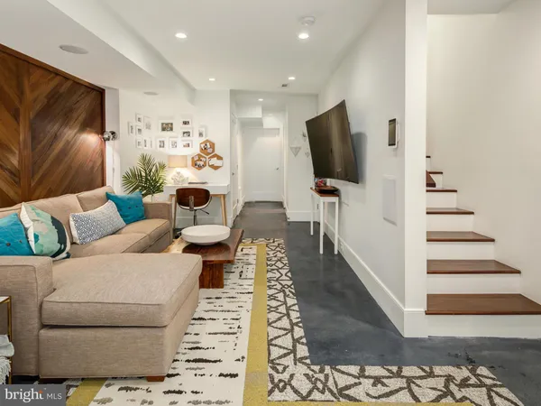 a kitchen with stainless steel appliances granite countertop a sink a stove a refrigerator and cabinets