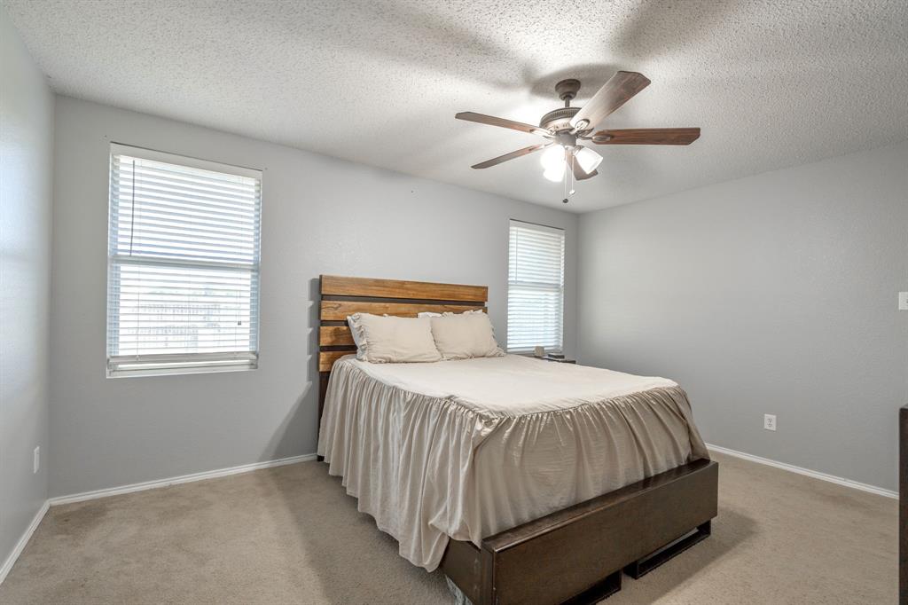 1973 Lariat Drive Fort Worth, TX 76247 - Photo 12 of 28 a bedroom with a bed and window