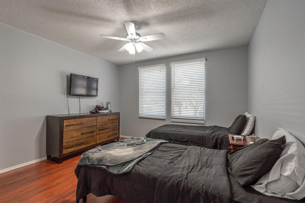 1973 Lariat Drive Fort Worth, TX 76247 - Photo 18 of 28 a bedroom with a bed and a mirror