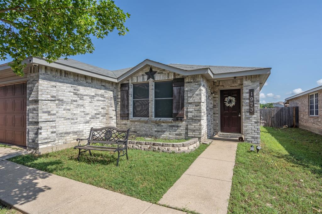 1973 Lariat Drive Fort Worth, TX 76247 - Photo 2 of 28 a front view of a house with garden