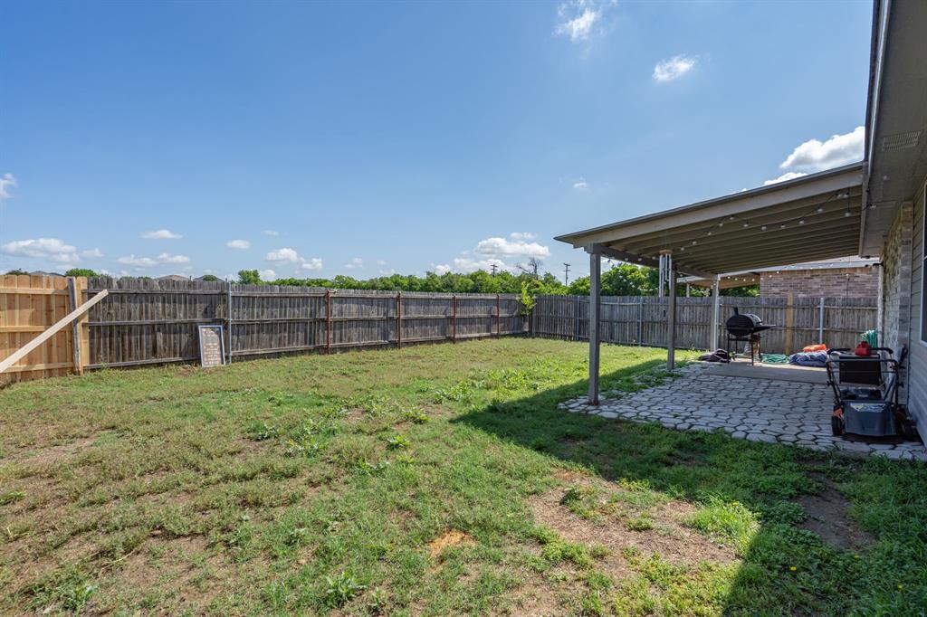 1973 Lariat Drive Fort Worth, TX 76247 - Photo 20 of 28 a view of a backyard with trampoline