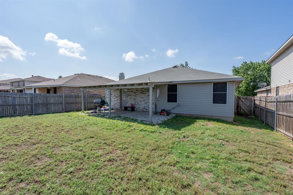 1973 Lariat Drive Fort Worth, TX 76247 - Photo 21 of 28 a view of a backyard with a garden