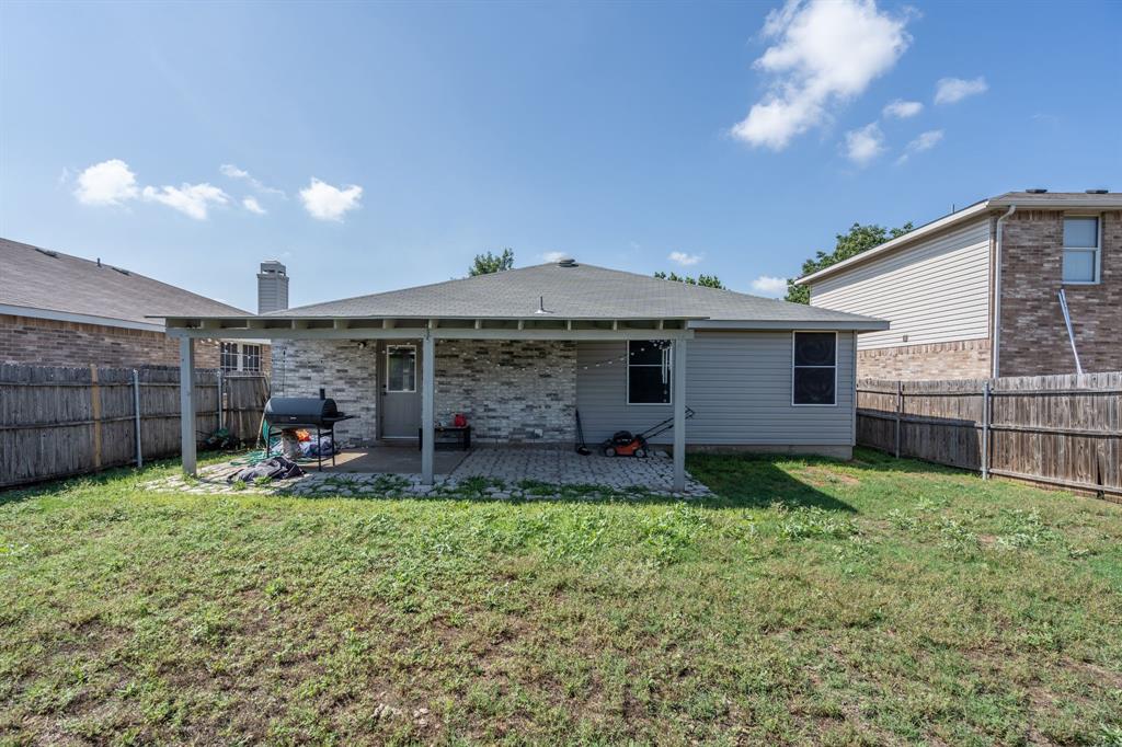 1973 Lariat Drive Fort Worth, TX 76247 - Photo 22 of 28 a view of a house with backyard and sitting area