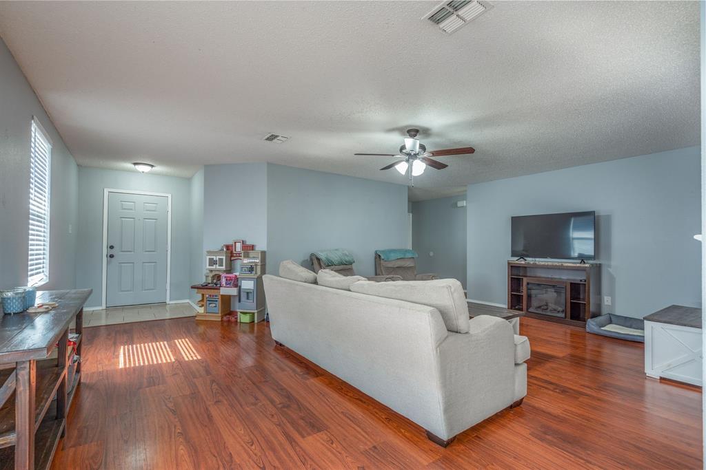 1973 Lariat Drive Fort Worth, TX 76247 - Photo 5 of 28 a living room with furniture and a flat screen tv